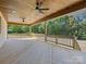Large covered wooden back porch with two ceiling fans and wood trim to provide shade and comfort to the occupants at 4539 Polk Ford Rd, Stanfield, NC 28163