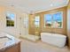 Bright bathroom with stand alone tub, glass shower and a large window with a view at 4539 Polk Ford Rd, Stanfield, NC 28163