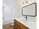 Bright bathroom featuring wood-look floors, a white countertop, a black framed mirror and matching fixtures at 4539 Polk Ford Rd, Stanfield, NC 28163