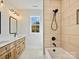 Bathroom featuring double vanity and a tub shower combo at 4539 Polk Ford Rd, Stanfield, NC 28163