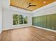 Bedroom features a wood tray ceiling, large picture window, and accent wall at 4539 Polk Ford Rd, Stanfield, NC 28163