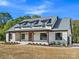 Charming home featuring a welcoming front porch, dormer windows, and a well-maintained lawn at 4539 Polk Ford Rd, Stanfield, NC 28163
