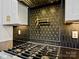 This kitchen features a black, gold, and white color palette with a pot filler above the stovetop at 4539 Polk Ford Rd, Stanfield, NC 28163