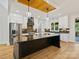 Modern kitchen with large island, stainless appliances, custom cabinets, and decorative lighting at 4539 Polk Ford Rd, Stanfield, NC 28163