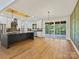 Spacious kitchen with stainless steel appliances, island, and sliding glass doors to the outdoor living area at 4539 Polk Ford Rd, Stanfield, NC 28163