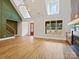 Open-concept area featuring wood floors, high ceilings, fireplace, and large windows with backyard views at 4539 Polk Ford Rd, Stanfield, NC 28163