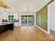 Open living area with hardwood floors, large sliding glass doors, and a decorative green wall at 4539 Polk Ford Rd, Stanfield, NC 28163