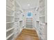 The closet features custom shelving, drawers, and laminate floors for a great organizational system at 4539 Polk Ford Rd, Stanfield, NC 28163