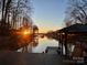 Stunning sunset view over calm lake waters from a lakeside deck at 466 Lakeview Shores Loop, Mooresville, NC 28117