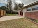 Backyard with patio, carport, and partial brick fence at 505 Turner St, Landis, NC 28088