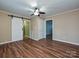 Bedroom with hardwood floors, ceiling fan, and barn door at 505 Turner St, Landis, NC 28088