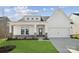 House exterior boasts a charming farmhouse design with stone accents and a two-car garage at 9088 El Sworth Dr, Sherrills Ford, NC 28673