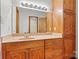 Bathroom with wood vanity, large mirror, and built-in shelving at 448 Johnson Dairy Rd, Mooresville, NC 28115