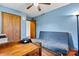 Bedroom with wood floors, a daybed, and double doors leading to a closet at 448 Johnson Dairy Rd, Mooresville, NC 28115