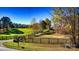 Long driveway entrance to home with wooden fence and autumn trees at 448 Johnson Dairy Rd, Mooresville, NC 28115