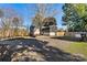 House exterior view with gravel driveway and screened porch at 448 Johnson Dairy Rd, Mooresville, NC 28115