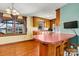 Kitchen with wood cabinets, laminate flooring, and a breakfast bar at 448 Johnson Dairy Rd, Mooresville, NC 28115