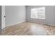 Simple bedroom with hardwood floors and a window at 7039 Executive Cir, Denver, NC 28037