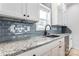 Kitchen features granite countertops and gray tile backsplash at 7039 Executive Cir, Denver, NC 28037