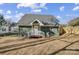 Green house exterior with backyard and wooden fence at 102 S Liberty St, Gastonia, NC 28052