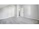 Simple bedroom with gray carpet and white doors at 102 S Liberty St, Gastonia, NC 28052