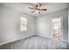 Bright bedroom with ceiling fan, carpet, and access to a full bathroom at 102 S Liberty St, Gastonia, NC 28052