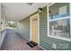 Inviting front porch with a yellow door and white railing at 102 S Liberty St, Gastonia, NC 28052