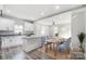 Open concept kitchen with island and dining area, featuring hardwood floors at 102 S Liberty St, Gastonia, NC 28052