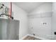 Convenient laundry room with shelving and hookups at 102 S Liberty St, Gastonia, NC 28052