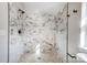 Modern shower with marble-patterned hexagonal tiles and a mosaic floor at 102 S Liberty St, Gastonia, NC 28052