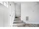 Modern staircase with gray carpeting and white railing at 102 S Liberty St, Gastonia, NC 28052