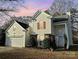 Two-story house with attached garage and landscaping at 13039 Peacock Ln, Charlotte, NC 28215