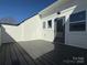 Spacious outdoor deck or patio area with gray flooring and crisp white siding for outdoor living and relaxation at 1419 Collier Walk Aly # Csw0208, Charlotte, NC 28205