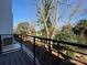 Relaxing balcony view with mature trees creating a peaceful outdoor living space at 1419 Collier Walk Aly # Csw0208, Charlotte, NC 28205