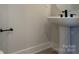 Modern pedestal sink and black hardware in bathroom at 1419 Collier Walk Aly # Csw0208, Charlotte, NC 28205