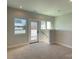 Bright bonus room boasts neutral walls, plush carpeting, and a door to an outdoor area at 1419 Collier Walk Aly # Csw0208, Charlotte, NC 28205