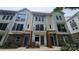 Charming townhouse features a modern facade with brick accents, a walkway, and upper level balconies at 1419 Collier Walk Aly # Csw0208, Charlotte, NC 28205