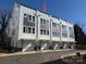 Three-story townhome complex with siding, multiple windows, garages, and street access at 1419 Collier Walk Aly # Csw0208, Charlotte, NC 28205