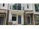 A charming home featuring a brick facade, creating a welcoming and stylish entrance at 1419 Collier Walk Aly # Csw0208, Charlotte, NC 28205