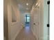 Hallway showcasing hardwood floors, neutral walls, and a staircase with modern railings, and view to a room at 1419 Collier Walk Aly # Csw0208, Charlotte, NC 28205