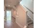 Bright hallway featuring hardwood floors, neutral walls, and a staircase with modern railings at 1419 Collier Walk Aly # Csw0208, Charlotte, NC 28205