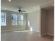 Living room with light-colored floors, recessed lighting, fan and multiple windows at 1419 Collier Walk Aly # Csw0208, Charlotte, NC 28205
