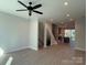 Spacious living room with light-colored floors, recessed lighting, and view to staircase and kitchen at 1419 Collier Walk Aly # Csw0208, Charlotte, NC 28205
