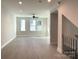 Living room with light-colored floors, recessed lighting, fan and multiple windows at 1419 Collier Walk Aly # Csw0208, Charlotte, NC 28205