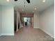 Open-concept living room shows light-colored floors, recessed lighting, stairs, and view to kitchen at 1419 Collier Walk Aly # Csw0208, Charlotte, NC 28205