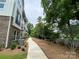 Townhome with landscaped side yard and walkway leading to a community green space at 1419 Collier Walk Aly # Csw0208, Charlotte, NC 28205