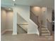 View of the staircase with metal and wooden railings at 1419 Collier Walk Aly # Csw0208, Charlotte, NC 28205
