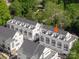 Aerial view of townhomes nestled among trees showcasing rooflines, windows, and neighborhood layout at 1421 Collier Walk Aly # Csw0209, Charlotte, NC 28205