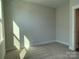 Well-lit bedroom with neutral walls and carpet at 1421 Collier Walk Aly # Csw0209, Charlotte, NC 28205