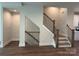 Inviting entryway featuring hardwood floors, modern staircase with iron railings, and neutral paint colors at 1421 Collier Walk Aly # Csw0209, Charlotte, NC 28205